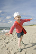 Little girl playing on the beach