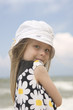 Cheerful girl in beautiful dress and hat