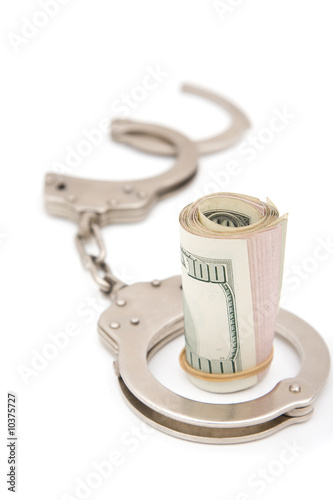 business fraud concept with handcuff and usd dollars