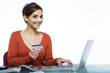 Photo: Young woman ordering online smiling Young woman ordering online smiling