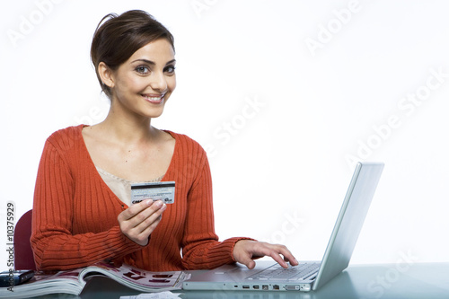 Photo : Young woman ordering online smiling Young woman ordering online smiling