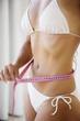 female measuring waist