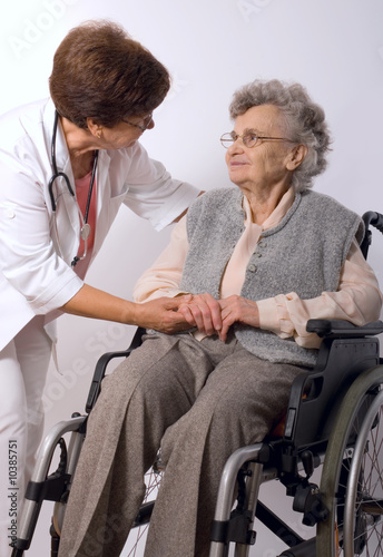 Photo: Health care worker and elderly woman in wheelchair Health care worker and elderly woman in wheelchair