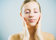 Young beautiful woman massaging face.