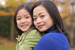 Mother and daughter pose for photo shoots in the park