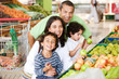 Family shopping in supermarket for some fruits