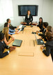 businesspeople in a business meeting in an office smiling