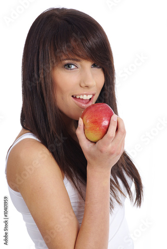 Foto: young woman holding apple. Isolated over white young woman holding apple. Isolated over white