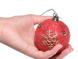 The female hand holds a Christmas ornament. Evening ball.