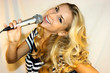 Beautiful blond standing with microphone in her hands Beautiful blond standing with microphone in her hands