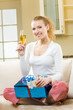 Young happy smiling woman with champagne and gifts