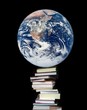 Planet Earth on books on a black background