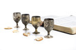 Four small cups with wine and bread. Communion