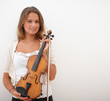 Smiling woman holding a violin next to copyspace