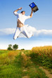 Happy farmer jumping with laptop