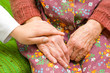 A doctor holding an old woman's hand - part of a series.