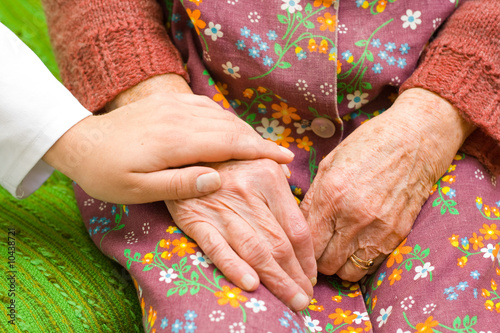 Photo: A doctor holding an old woman's hand - part of a series. A doctor holding an old woman's hand - part of a series.