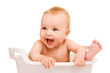 Cute baby having bath in white tub