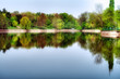 Picturesque park landscape: colorful trees reflecting in water