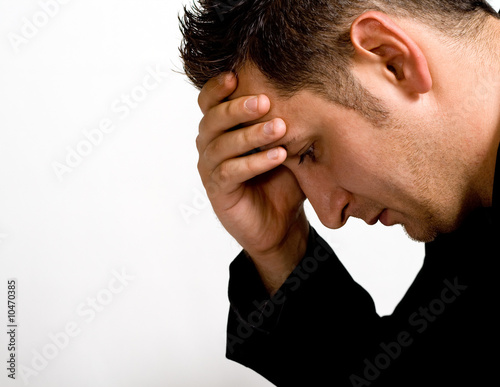 Photo: Portrait of depressed young businessman isolated on white Portrait of depressed young businessman isolated on white