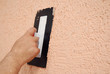 hand holding a plastering tool finishing renovating the wall