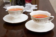 two porcelain cups with tea