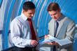 Foto: Two successful young business men watching report Two successful young business men watching report
