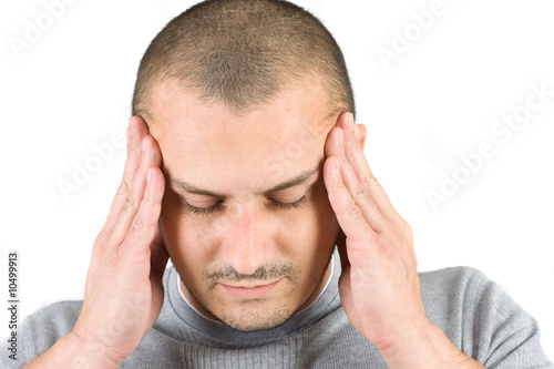 Photo: Young man with migraine isolated on white Young man with migraine isolated on white
