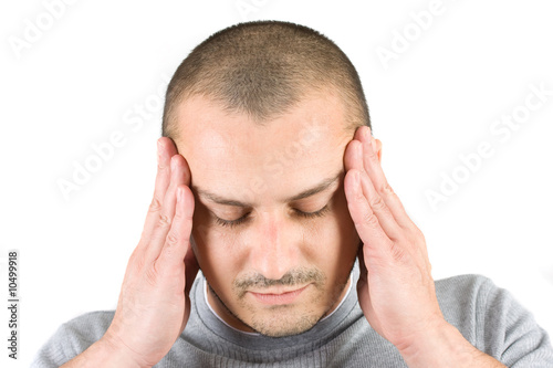 Photo: Young man with migraine isolated on white Young man with migraine isolated on white