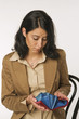 Young woman holding purse, portrait