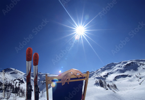 Photo: Person sitting in deckchair in alps, winter Person sitting in deckchair in alps, winter