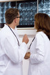 Male doctor and a female doctor examining an x-ray report