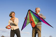 Senior couple, man holding kite Senior couple, man holding kite