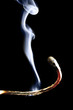 Burnt matchstick on black background, close-up