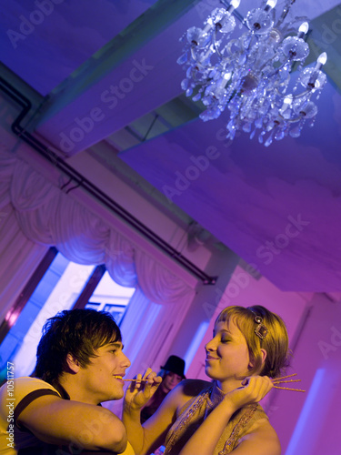 Foto: Young couple on party with pretzel sticks Young couple on party with pretzel sticks