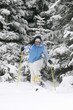 Young woman snowshoeing, laughing