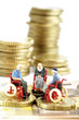 Figurines in wheelchairs on coins