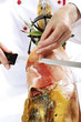 Cook cutting serrano ham