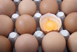 close up of open egg in egg box