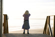 Portugal, Algarve, girl (5-7) standing at beach, rear view