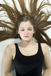 Brunette girl (13 years), eyes closed, portrait