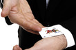 Man extracting playing card out of sleeve, close-up, mid section
