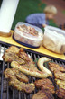 Sausages and meat on barbecue, close-up