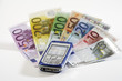 Mobile phone on bank notes, close-up