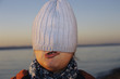 Girl hiding under cap
