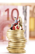 Figurines, senior citizens, on pile of coins