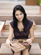 Woman holding spice box, smiling