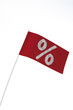 White percent sign on red flag, symbol for bargain