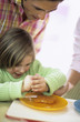 Young boy squeezing lemon over fish sticks