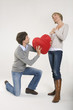 Couple, Young man kneeling in front of young woman, portrait
